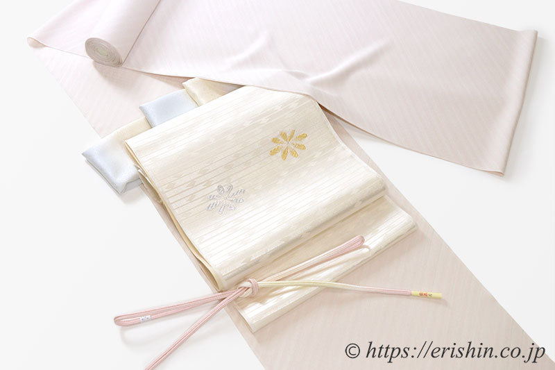 小紋(しけ引き/薄桜色)に九寸織名古屋帯(花菱文)