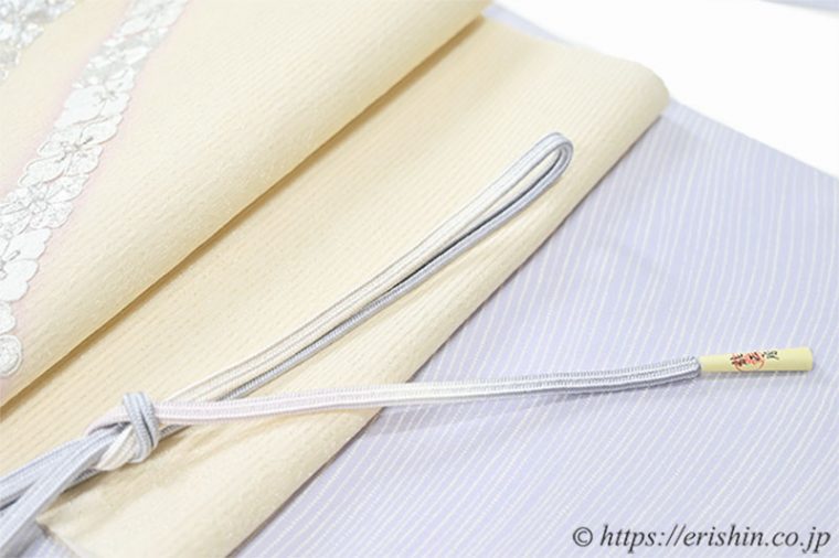 小紋（波の縞/淡藤色）に九寸織名古屋帯（たすき花菱）