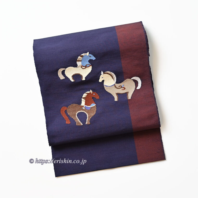 洛風林　八寸織名古帯（馬のつどい/茄子紺色×鳶色の縞）「着物と帯・呉服えり新」